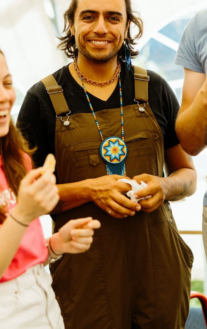 Ro smiling, with a beaded star medallion